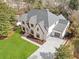 Stunning exterior view of a traditional brick home with a lush green lawn and well-manicured landscaping at 4895 Lansbury Dr, Atlanta, GA 30342