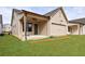 Lawn and backyard of home has exterior lighting and covered back porch at 158 South Village Ave, Holly Springs, GA 30115
