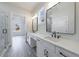 Bathroom featuring double vanity with a door leading to glass enclosed shower at 158 South Village Ave, Holly Springs, GA 30115