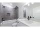 Bathroom features white marble countertop, deep tub, and gray tiling at 158 South Village Ave, Holly Springs, GA 30115