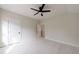 A light-filled bedroom with a modern ceiling fan and freshly painted neutral walls at 158 South Village Ave, Holly Springs, GA 30115