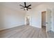 A bedroom with vaulted ceiling and ensuite bathroom through a white, open door at 158 South Village Ave, Holly Springs, GA 30115