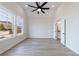 Bright, open bedroom with large windows and an ensuite bathroom through a white, open door at 158 South Village Ave, Holly Springs, GA 30115