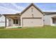 Garage has a wide door with matching cream-colored exterior walls and roofing at 158 South Village Ave, Holly Springs, GA 30115