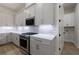 The kitchen features stainless steel appliances, white countertops, and modern cabinetry at 158 South Village Ave, Holly Springs, GA 30115