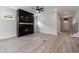 Living room features an electric fireplace with black surround and wooden mantle over light colored flooring at 158 South Village Ave, Holly Springs, GA 30115