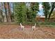 The backyard patio area features two white lawn chairs in a peaceful setting at 5063 White Sw Blvd, Mableton, GA 30126