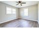 Well-lit bedroom with neutral paint, ceiling fan and hardwood floors at 5063 White Sw Blvd, Mableton, GA 30126