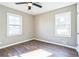 Cozy bedroom offers neutral paint, ceiling fan and hardwood floors at 5063 White Sw Blvd, Mableton, GA 30126