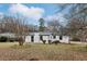Exterior view of home with a manicured lawn and fresh white paint with black trim at 5063 White Sw Blvd, Mableton, GA 30126