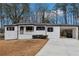 Charming single-story home featuring white painted brick, a covered front porch, and an attached carport at 5063 White Sw Blvd, Mableton, GA 30126