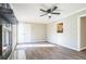 Bright living room with hardwood floors, fireplace, and natural light streaming in through a window to the kitchen at 5063 White Sw Blvd, Mableton, GA 30126