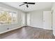 Inviting living room with ample natural light, hardwood floors, and multiple doors for easy access at 5063 White Sw Blvd, Mableton, GA 30126