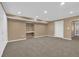Open basement area with neutral walls and carpet and cabinets for storage at 2020 Stockton Walk Ln, Snellville, GA 30078