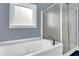 Bathroom featuring a jetted tub, and a glass-enclosed shower at 2020 Stockton Walk Ln, Snellville, GA 30078