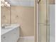 Well-lit renovated bathroom featuring a marble vanity top, white cabinets, and glass enclosed shower at 2020 Stockton Walk Ln, Snellville, GA 30078