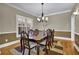 Inviting dining room with wooden table, chairs, decorative lighting, and hardwood floor at 2020 Stockton Walk Ln, Snellville, GA 30078