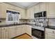 Close up of the kitchen with stainless steel oven and cream cabinets at 2020 Stockton Walk Ln, Snellville, GA 30078