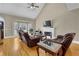 Bright living room with hardwood floors, fireplace, and large windows at 2020 Stockton Walk Ln, Snellville, GA 30078