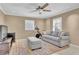 Cozy living room featuring a gray sofa, ceiling fan, neutral walls, and tile flooring at 2020 Stockton Walk Ln, Snellville, GA 30078