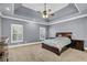 Large main bedroom with gray walls, carpet floors, and many windows at 2020 Stockton Walk Ln, Snellville, GA 30078