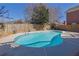 Backyard view of the in-ground pool with a concrete surround and wooden fence and various seating at 2020 Stockton Walk Ln, Snellville, GA 30078