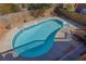 Aerial view of kidney-shaped inground pool with wooden fence, and concrete patio. Seating available at 2020 Stockton Walk Ln, Snellville, GA 30078