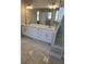 Modern bathroom with a glass-enclosed shower and a double vanity at 7260 Bluewater Ln, Douglasville, GA 30135