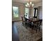 Dining room featuring wainscoting, an elegant table, chandelier, and natural light at 7260 Bluewater Ln, Douglasville, GA 30135