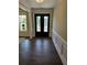 Elegant entryway with hardwood floors and a glass-paneled front door at 7260 Bluewater Ln, Douglasville, GA 30135