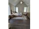 A bedroom featuring a vaulted ceiling, natural light, and neutral decor at 7260 Bluewater Ln, Douglasville, GA 30135