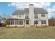 Rear exterior of home, showcasing sunroom, and fenced yard with patio area and landscaped yard at 114 Highgrove Pl, Mcdonough, GA 30253