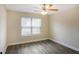 Bedroom with a ceiling fan, a window, and wood-look flooring at 114 Highgrove Pl, Mcdonough, GA 30253