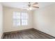 Cozy bedroom with wood-look flooring, ceiling fan and a bright window at 114 Highgrove Pl, Mcdonough, GA 30253