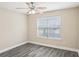 Bedroom with a ceiling fan, a window, and wood-look flooring at 114 Highgrove Pl, Mcdonough, GA 30253