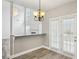 Open dining area with hardwood floors, french doors, and a view into the living area at 114 Highgrove Pl, Mcdonough, GA 30253