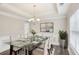 Elegant dining room with a glass table, tufted chairs, and modern decor at 114 Highgrove Pl, Mcdonough, GA 30253