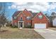 Beautiful two-story brick home featuring a well-manicured lawn and attached two-car garage at 114 Highgrove Pl, Mcdonough, GA 30253