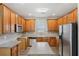Well-lit kitchen featuring stainless steel appliances, an island, and hardwood floors at 114 Highgrove Pl, Mcdonough, GA 30253