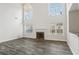 Bright living room featuring a fireplace, hardwood floors, and large windows at 114 Highgrove Pl, Mcdonough, GA 30253