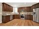 Spacious kitchen featuring stainless steel appliances, granite countertops, and wood floors at 117 Manous Dr, Canton, GA 30115