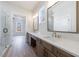 Bathroom featuring double vanities with white countertops, modern fixtures, and large mirrors at 160 South Village Ave, Holly Springs, GA 30115