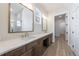 Bathroom featuring double vanities with white countertops, modern fixtures, and large mirrors at 160 South Village Ave, Holly Springs, GA 30115
