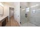 Bright bathroom with a glass enclosed shower and double vanity at 160 South Village Ave, Holly Springs, GA 30115