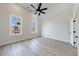 Bright bedroom with a vaulted ceiling, ceiling fan, and large windows at 160 South Village Ave, Holly Springs, GA 30115