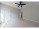 Bedroom with wood-look floors, a ceiling fan, and closet space at 160 South Village Ave, Holly Springs, GA 30115
