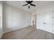 Bedroom with wood-look floors, a ceiling fan, and closet space at 160 South Village Ave, Holly Springs, GA 30115