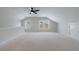 Large bonus room with bright windows, a ceiling fan, and plenty of space at 160 South Village Ave, Holly Springs, GA 30115