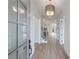 Welcoming entryway featuring hardwood floors, white walls, modern lighting, and staircase to the upper level at 160 South Village Ave, Holly Springs, GA 30115