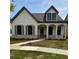 Charming single-Gathering home featuring white siding, stone accents, and a welcoming front porch with elegant columns at 160 South Village Ave, Holly Springs, GA 30115